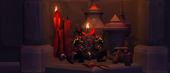 A plate-wearing warrior plops down, sitting with his legs spread in a concret inset in the wall. The inset contains large urns, an amulet, and lots of large burning candles, creating a feeling of brooding ambiance.